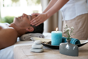 Man with candle getting massage